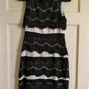 Very good condition. XSCAPE Beautiful Black lace dress with white underneath.